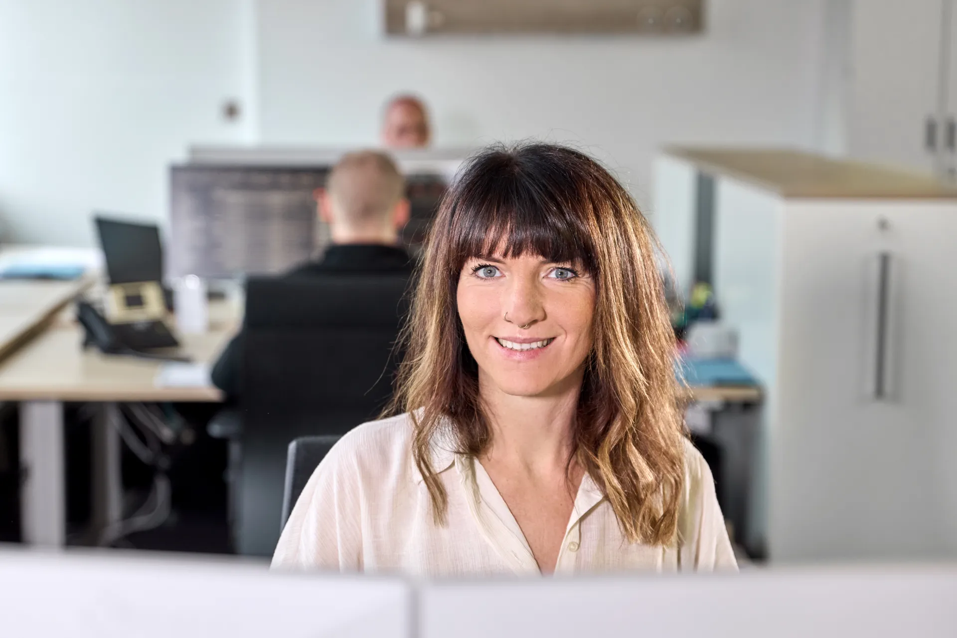 An employee smiles at the camera.