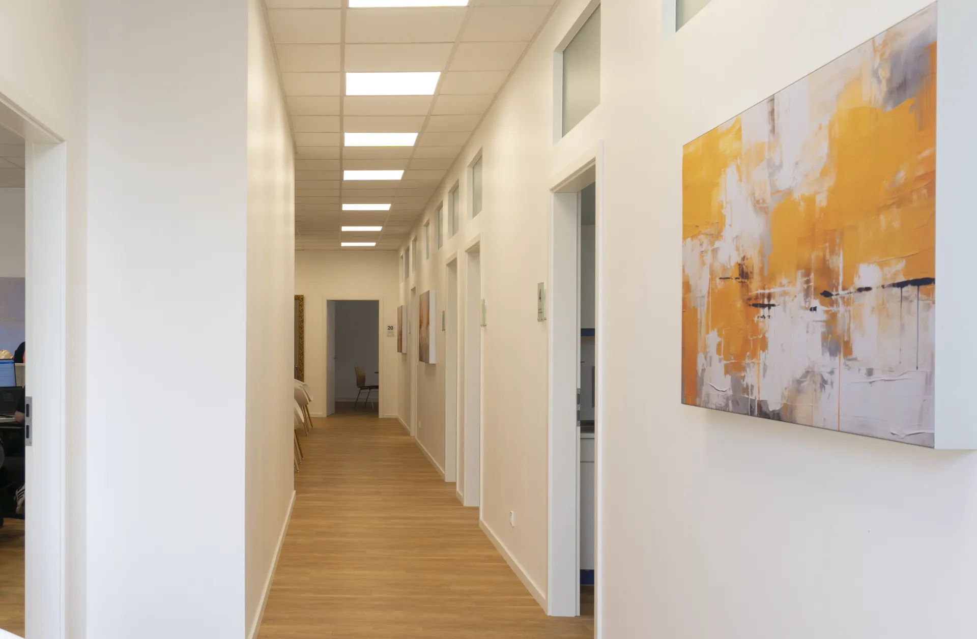 Corridor area of a practice with pleasantly bright ceiling lighting.