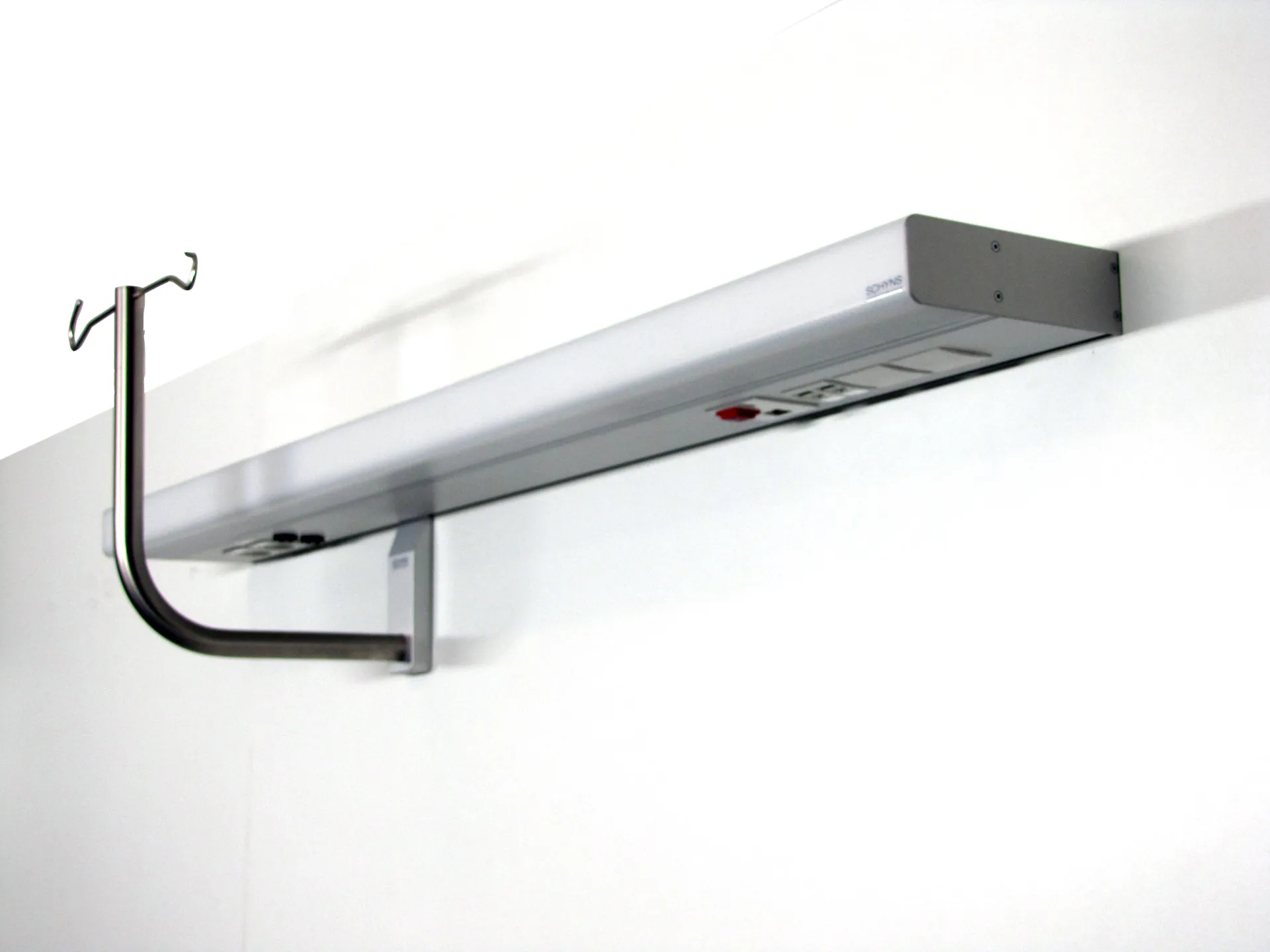 Infusion holder with two hooks in an elongated wall-mounted supply rail